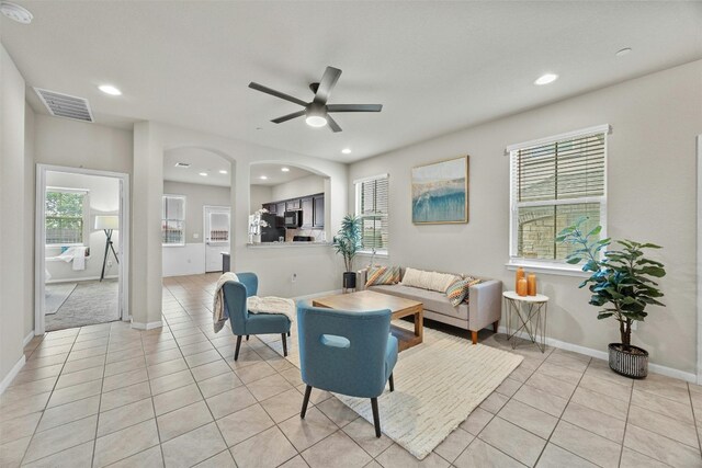 living room with light tile patterned flooring and ceiling fan