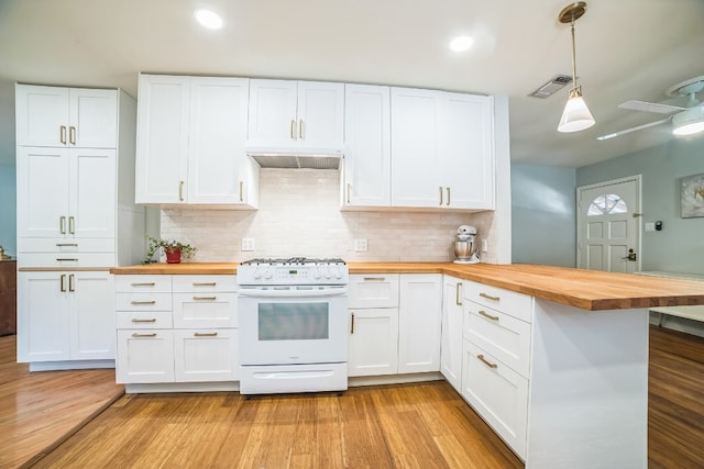 kitchen featuring pendant lighting, wooden counters, white gas range, and white cabinets