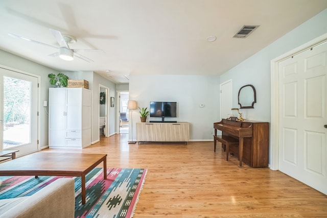 living room with ceiling fan and light hardwood / wood-style floors