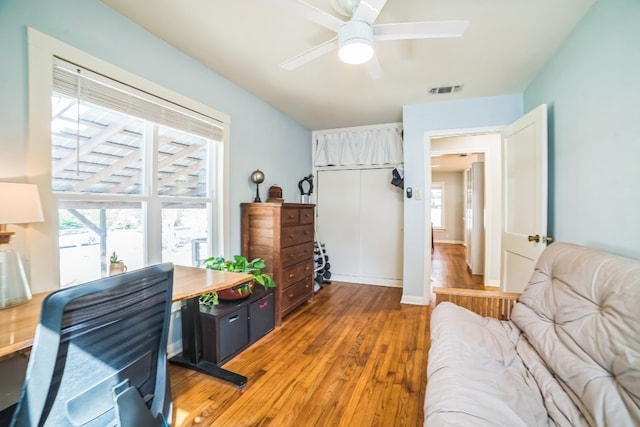 home office with hardwood / wood-style flooring and ceiling fan