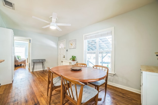 dining room with dark hardwood / wood-style flooring and ceiling fan