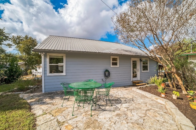 back of property with a patio