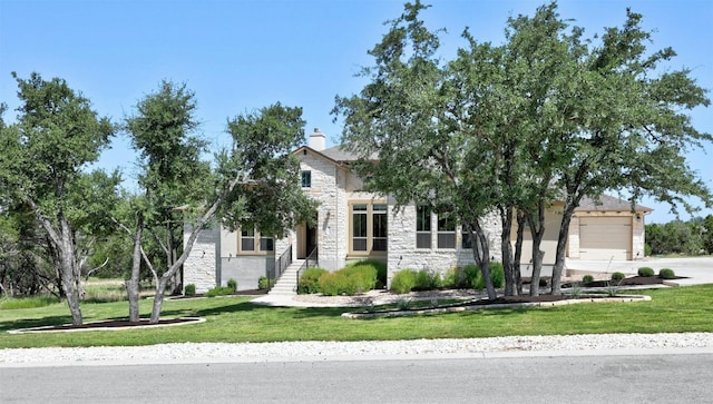 obstructed view of property featuring a front lawn and a garage