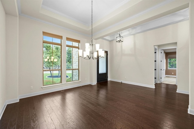 unfurnished dining area with ornamental molding, a tray ceiling, a chandelier, and dark hardwood / wood-style floors