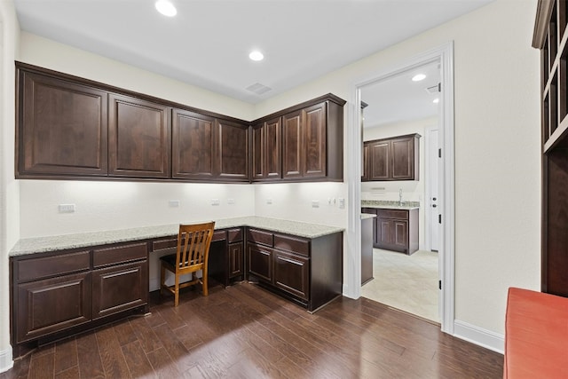 office area featuring dark hardwood / wood-style floors, built in desk, and sink