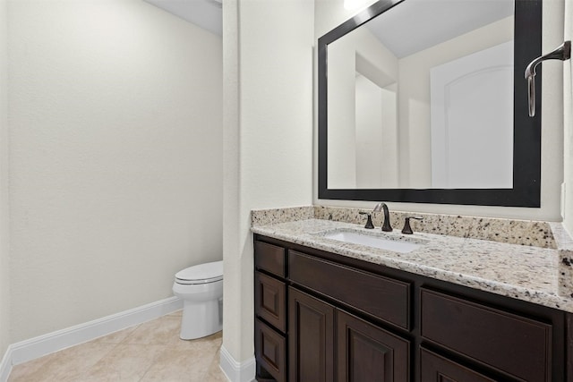 bathroom with vanity, toilet, and tile patterned flooring