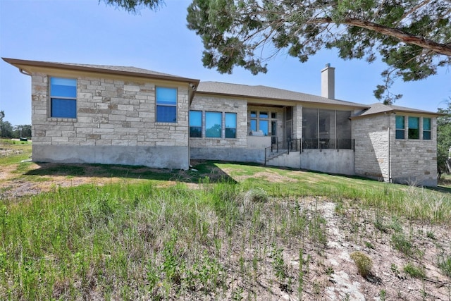 back of property with a sunroom