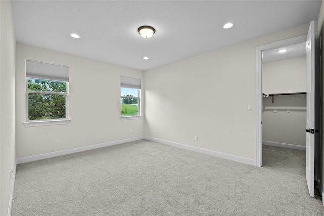 carpeted empty room featuring plenty of natural light