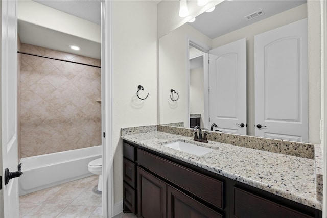 full bathroom with toilet, tiled shower / bath combo, vanity, and tile patterned floors