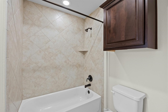 bathroom featuring toilet and tiled shower / bath