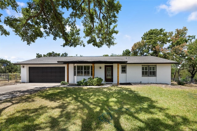 single story home featuring a front yard and a garage