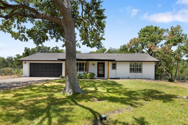 single story home with a front yard and a garage