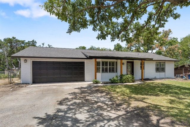 ranch-style house with a front lawn and a garage