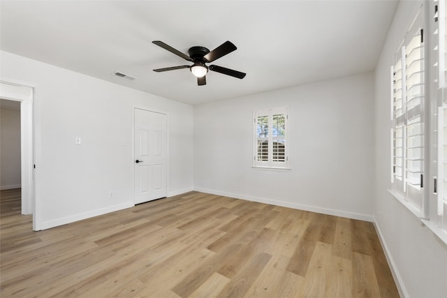 empty room featuring ceiling fan and light hardwood / wood-style flooring