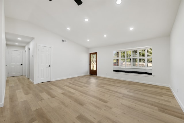 unfurnished living room with light hardwood / wood-style flooring, ceiling fan, and vaulted ceiling