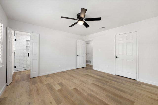 unfurnished bedroom with connected bathroom, light hardwood / wood-style floors, and ceiling fan