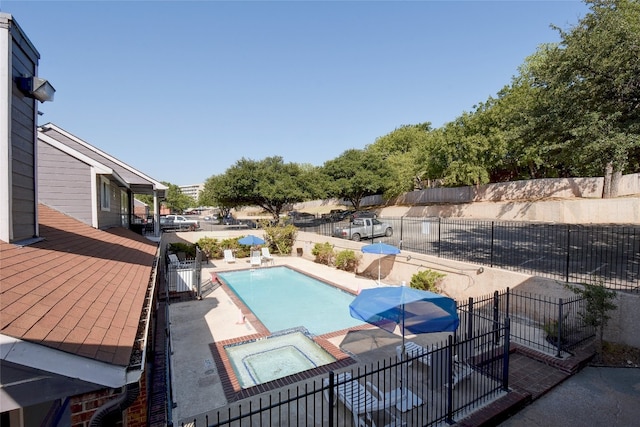 view of swimming pool featuring an in ground hot tub and a patio area