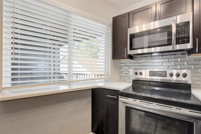 kitchen featuring dark brown cabinetry, stainless steel appliances, and tasteful backsplash