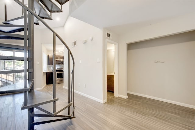 stairway with hardwood / wood-style floors