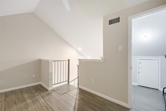 bonus room featuring lofted ceiling and hardwood / wood-style flooring