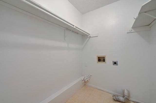 washroom featuring hookup for a washing machine, laundry area, hookup for an electric dryer, and baseboards