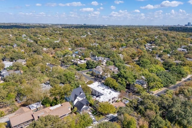 birds eye view of property with a view of trees