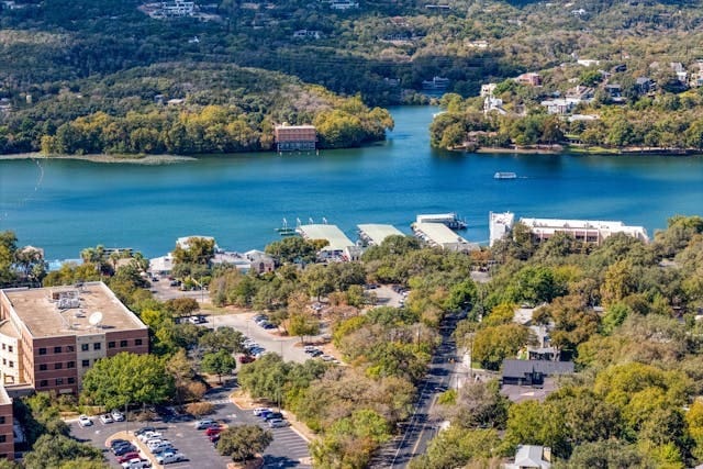 drone / aerial view featuring a water view and a forest view