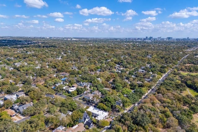 birds eye view of property with a forest view