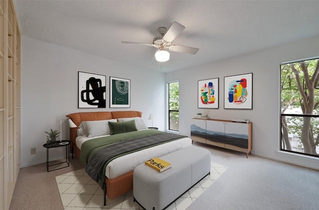 bedroom with ceiling fan and light colored carpet