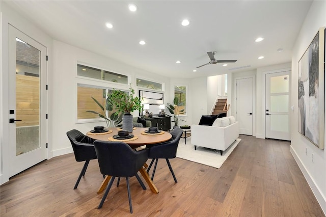 dining area featuring wood-type flooring and ceiling fan