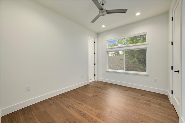 spare room featuring light hardwood / wood-style flooring and ceiling fan