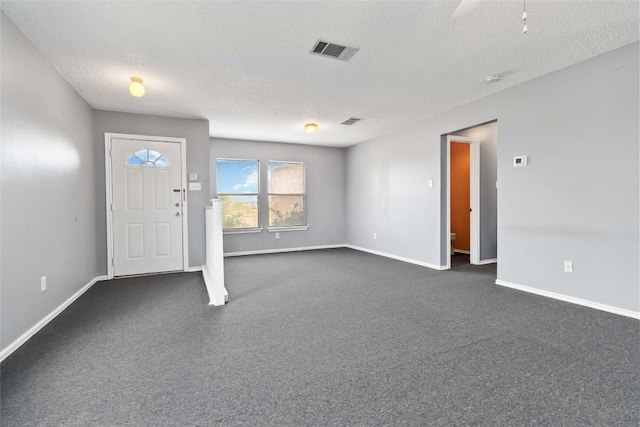 foyer with a textured ceiling and ceiling fan