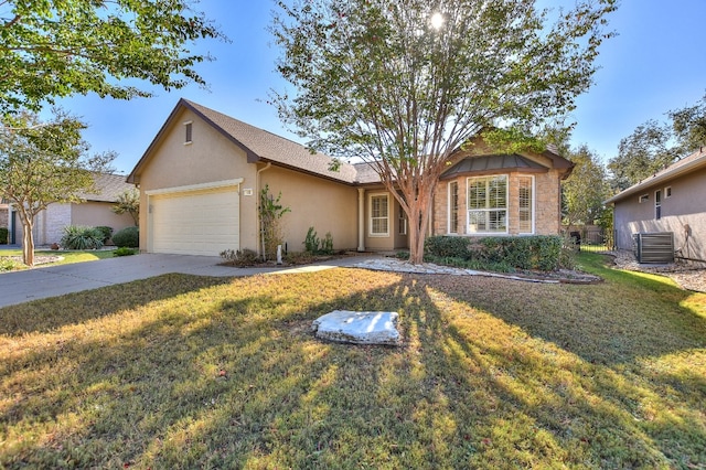 view of front facade with a front lawn, central AC, and a garage