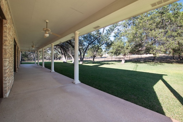 view of yard with a patio and ceiling fan