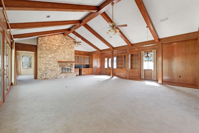 unfurnished living room featuring light carpet, high vaulted ceiling, a fireplace, and ceiling fan