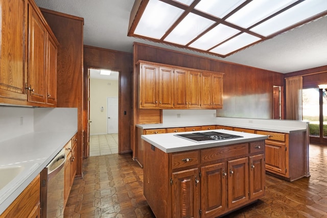 kitchen with wood walls, a center island, white stovetop, and dishwasher