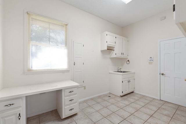 laundry area with sink and light tile patterned flooring