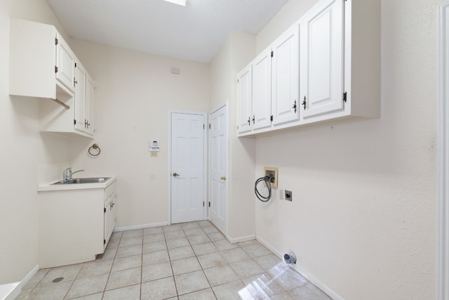 laundry area with cabinets, washer hookup, light tile patterned floors, hookup for an electric dryer, and sink