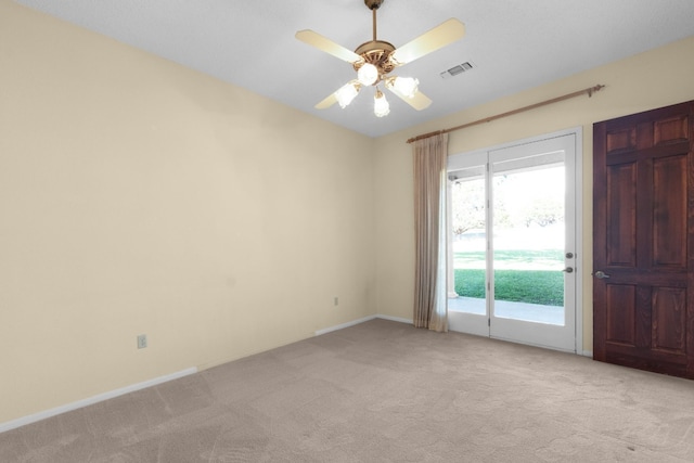 carpeted spare room with ceiling fan