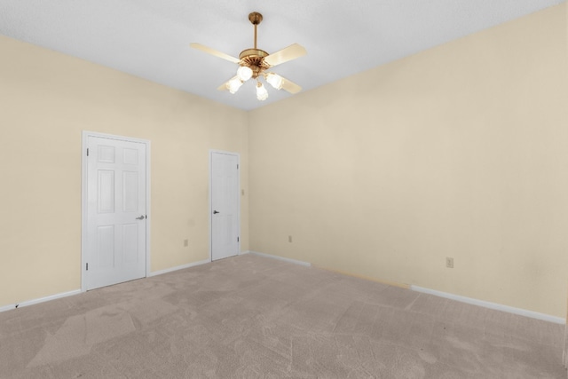 carpeted spare room featuring ceiling fan