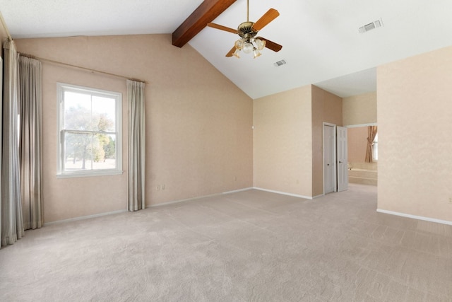 carpeted spare room featuring ceiling fan and lofted ceiling with beams