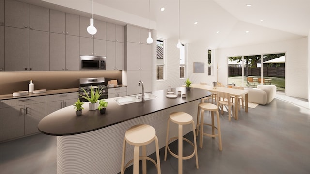 kitchen with stainless steel appliances, sink, vaulted ceiling, a breakfast bar, and decorative light fixtures