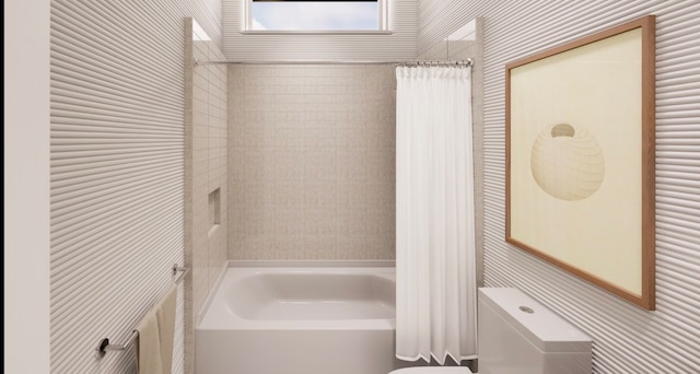 bathroom with toilet, tile walls, and shower / tub combo