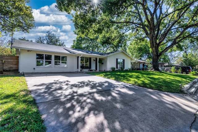 ranch-style home with a front lawn