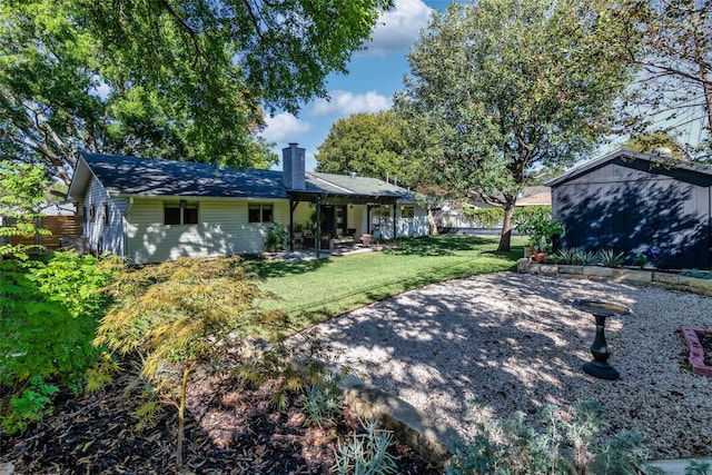 back of house featuring a yard and a patio