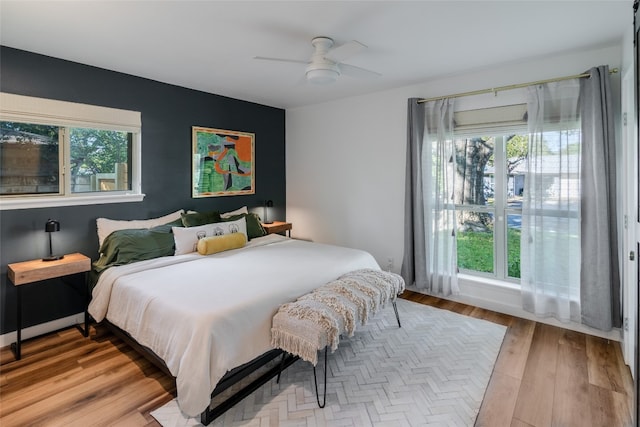 bedroom with light wood-type flooring and ceiling fan