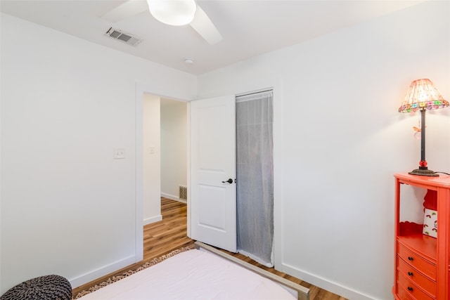 bedroom with hardwood / wood-style floors and ceiling fan