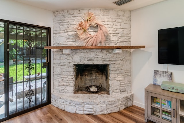 interior details featuring hardwood / wood-style flooring and a fireplace