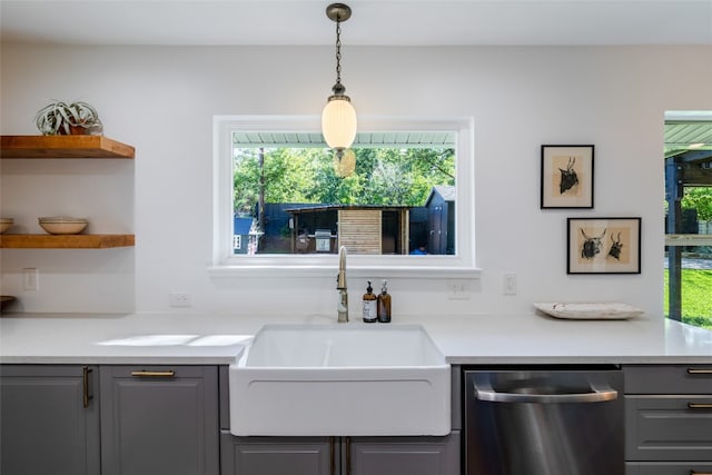 kitchen featuring gray cabinets, stainless steel dishwasher, sink, and plenty of natural light