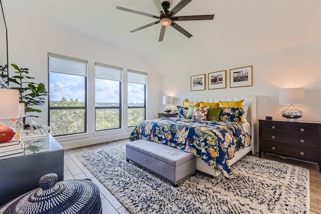 bedroom with light hardwood / wood-style floors, lofted ceiling, and ceiling fan